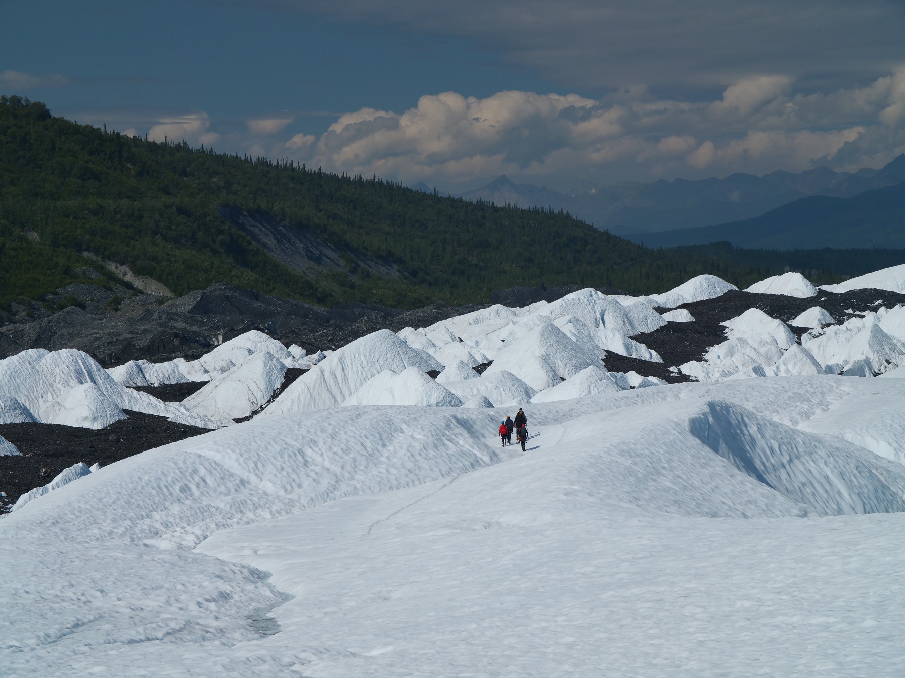 people walking on glacier ice
