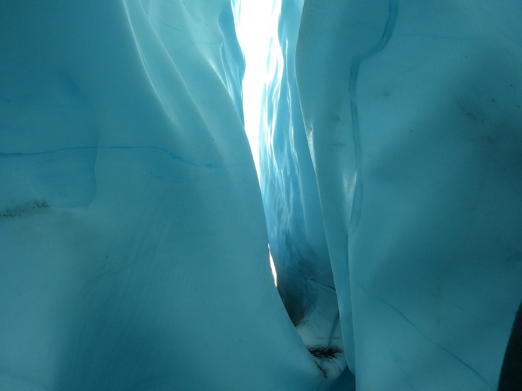 sunlight streaming into glacier crevasse